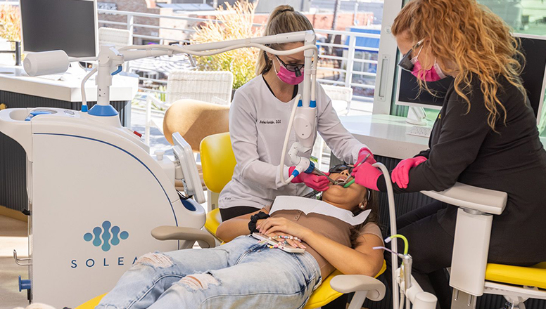 Dental clinicians using the Solea all-tissue laser with a patient