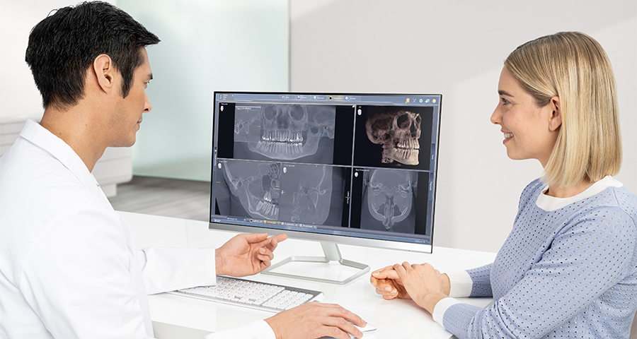 Dentist showing 3D CBCT images to a patient
