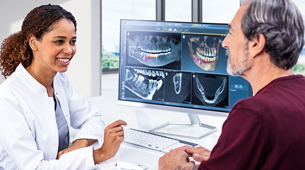 Dentist showing CBCT images to a patient