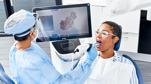 Dentist scanning a patients mouth and viewing the image on a screen