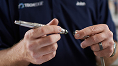 dental equipment repair technician working on a handpiece