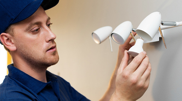 Patterson representative installing a light fixture in a dental office